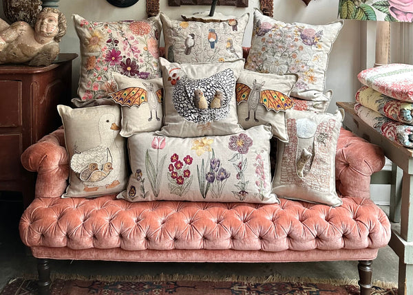 Group of embroidered pillows on a couch