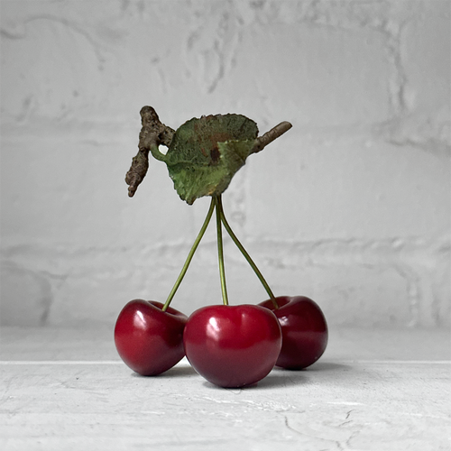 Three Porcelain Cherries with Leaf