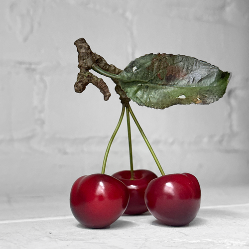 Three Porcelain Cherries with Leaf